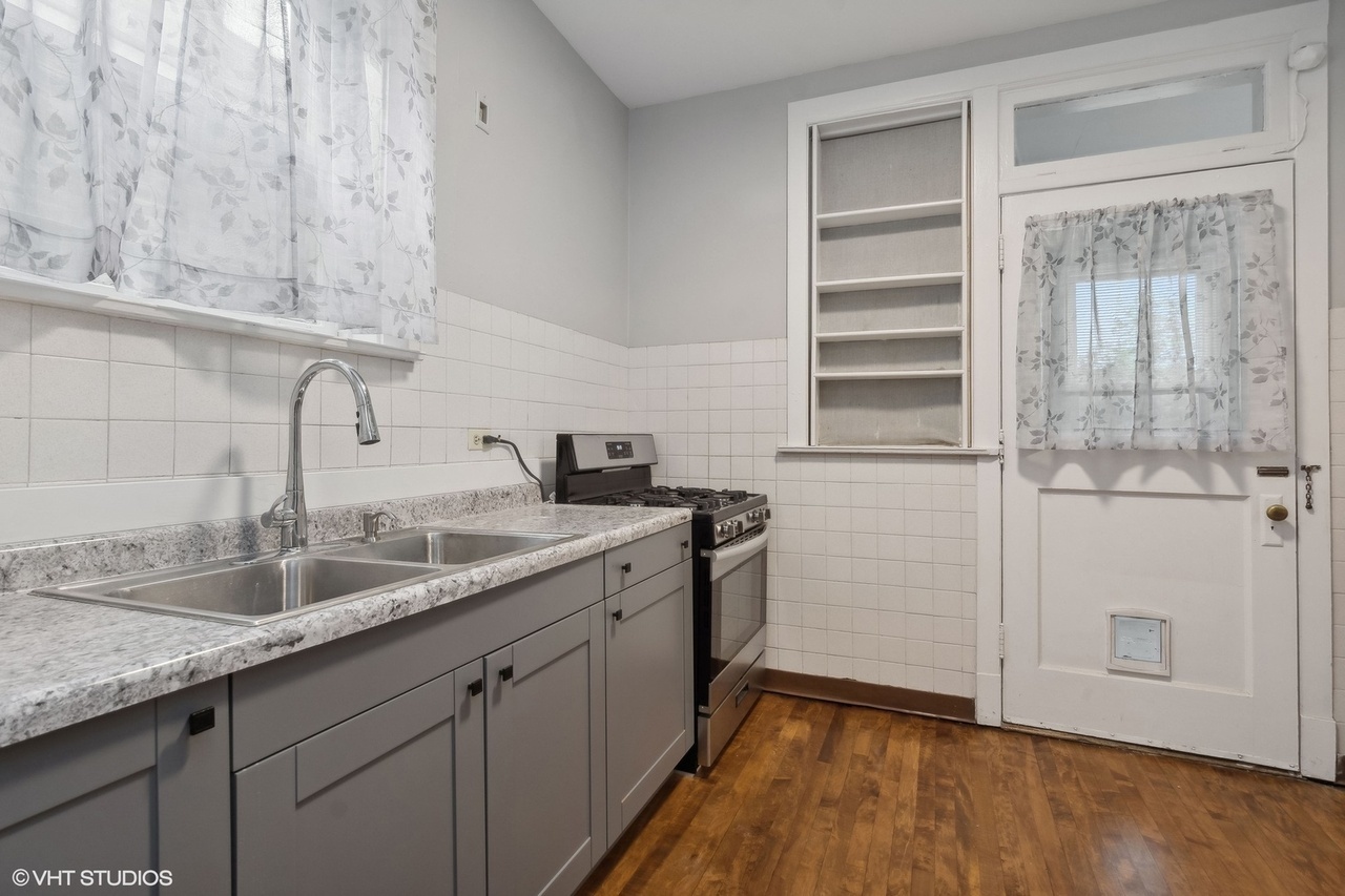1311 West Thorndale Avenue Chicago, IL 60660 - Photo 16 of 28 a kitchen with a sink and cabinets
