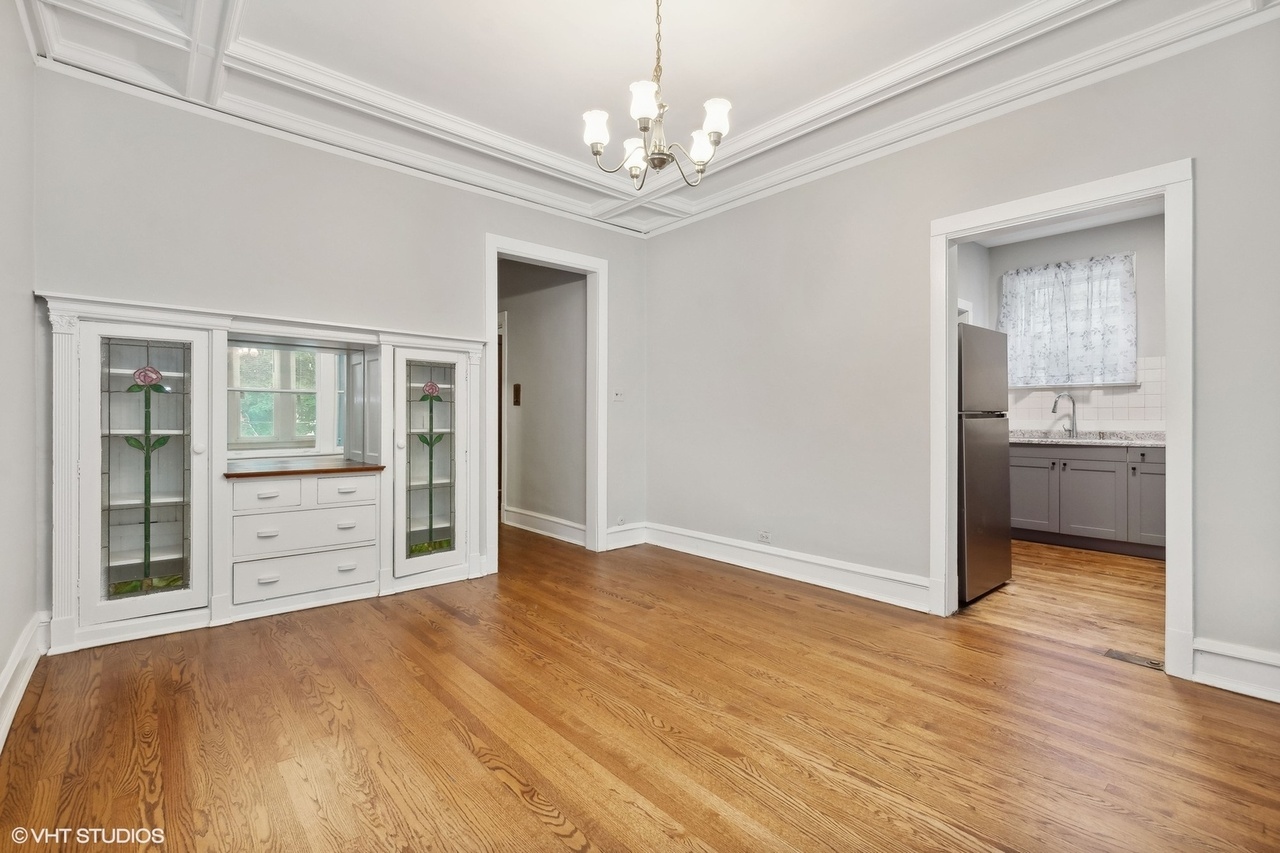 1311 West Thorndale Avenue Chicago, IL 60660 - Photo 17 of 28 a view of a livingroom with wooden floor a ceiling fan and windows