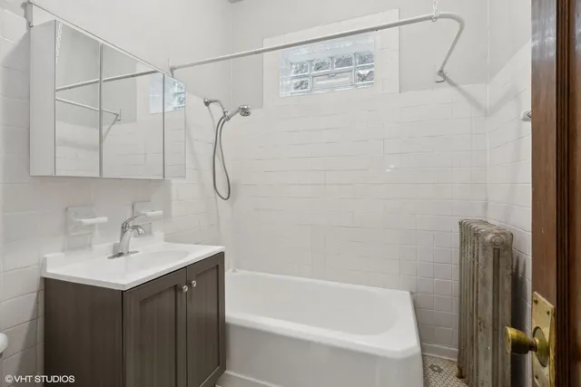 a bathroom with a shower sink and vanity