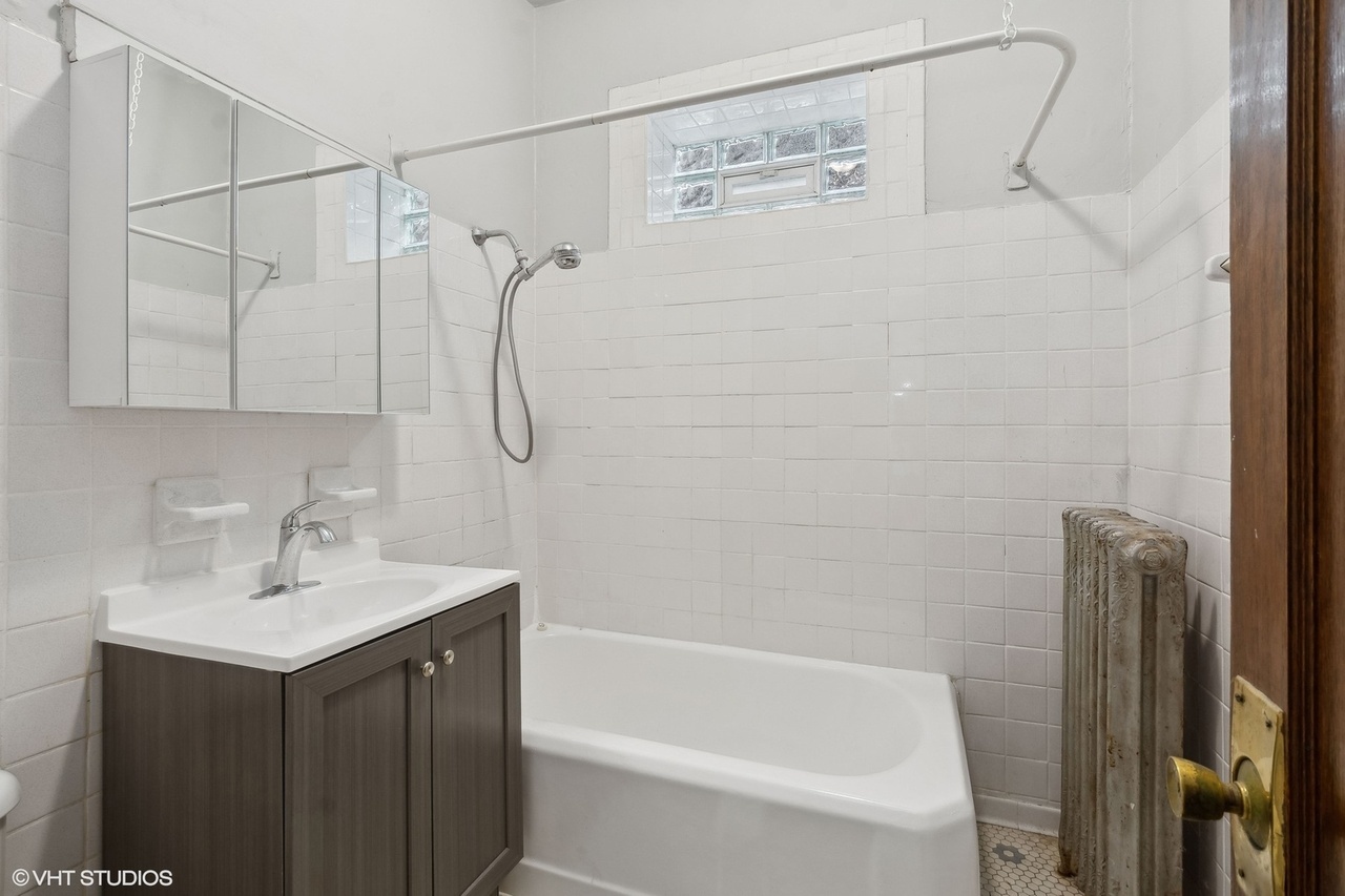 1311 West Thorndale Avenue Chicago, IL 60660 - Photo 18 of 28 a bathroom with a shower sink and vanity