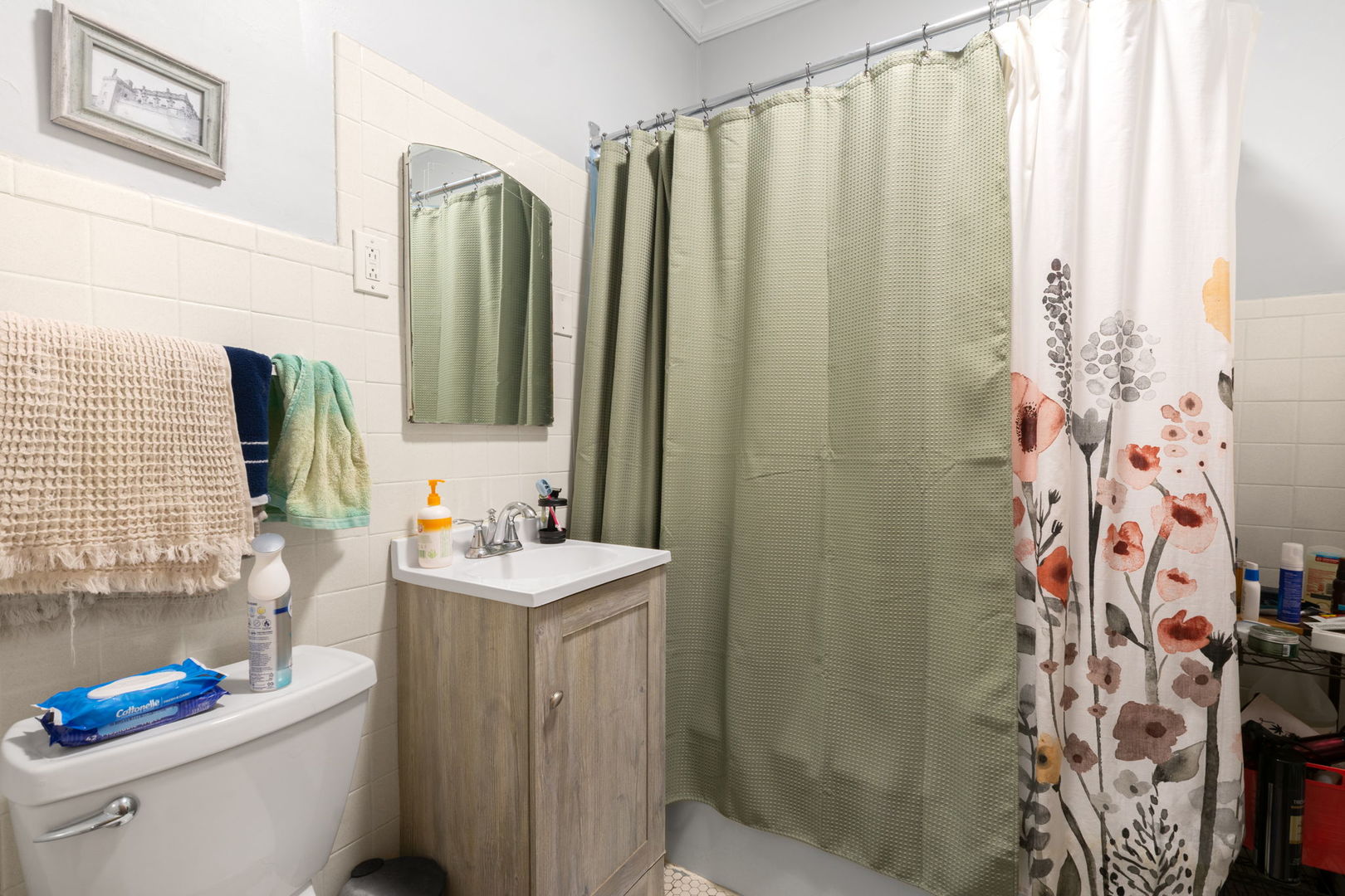 1311 West Thorndale Avenue Chicago, IL 60660 - Photo 22 of 28 a bathroom with a sink a toilet and shower curtain