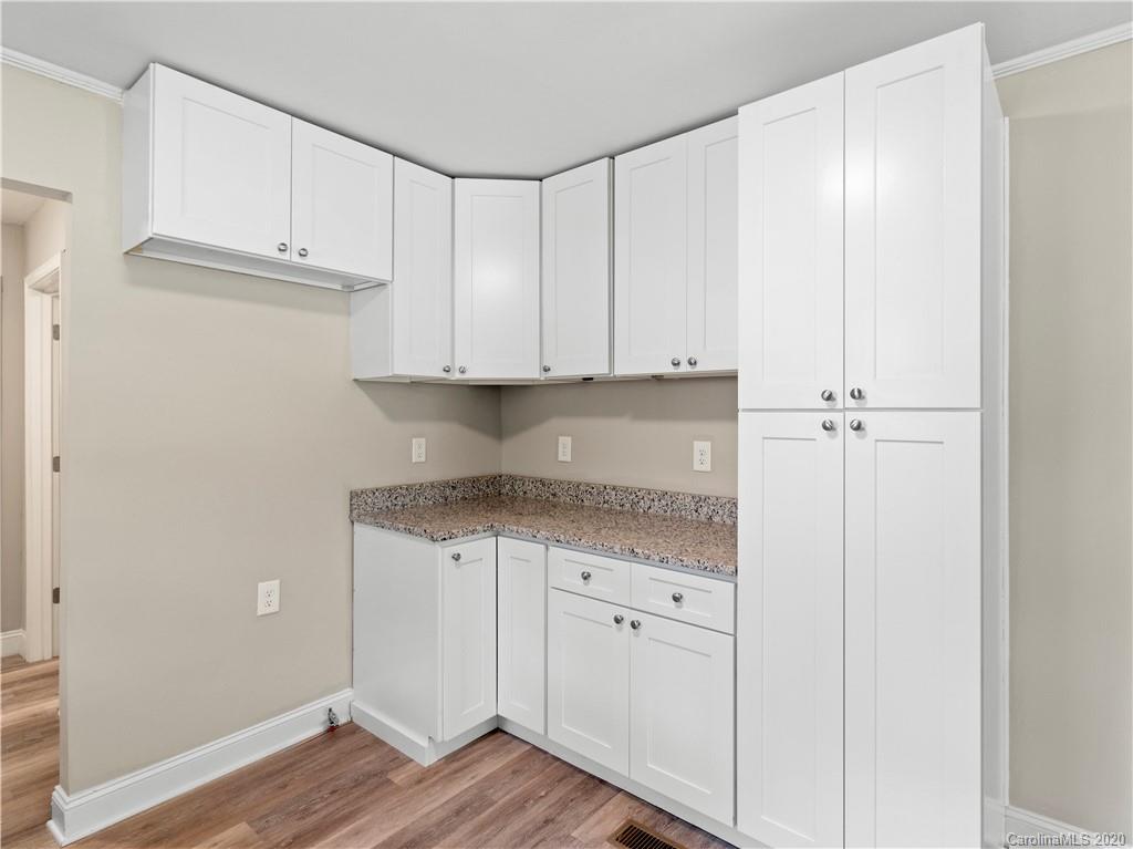 4152 Blenhein Road Charlotte, NC 28208 - Photo 17 of 34 a kitchen with granite countertop cabinets and white appliances