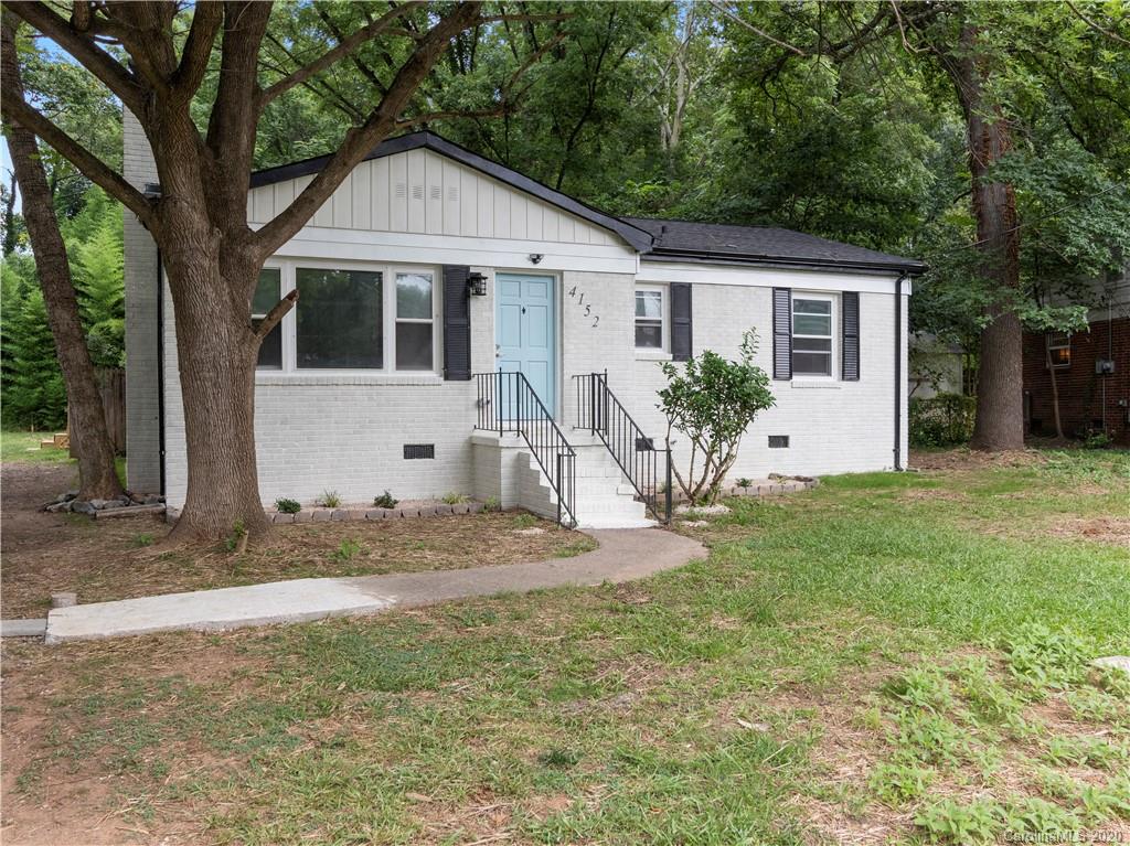 4152 Blenhein Road Charlotte, NC 28208 - Photo 3 of 34 a view of a yard in front of a house with large tree