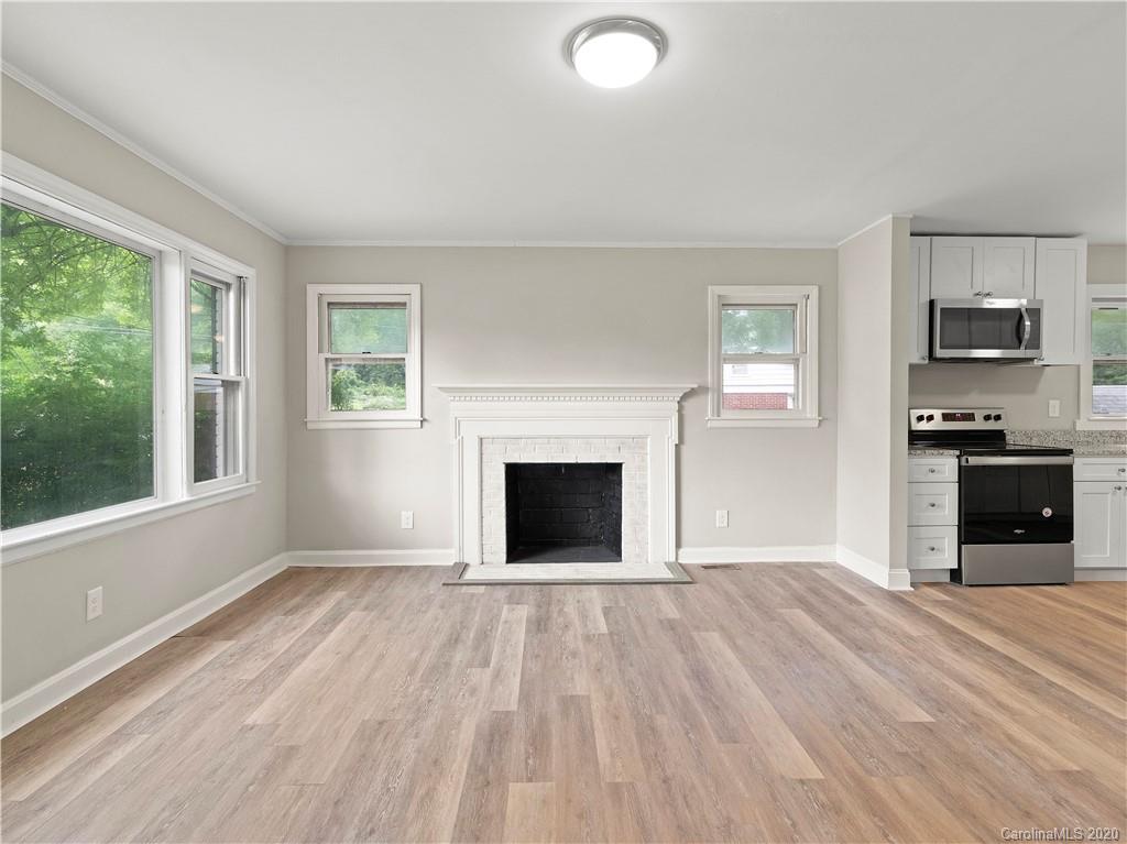 4152 Blenhein Road Charlotte, NC 28208 - Photo 22 of 34 an empty room with windows and a fireplace