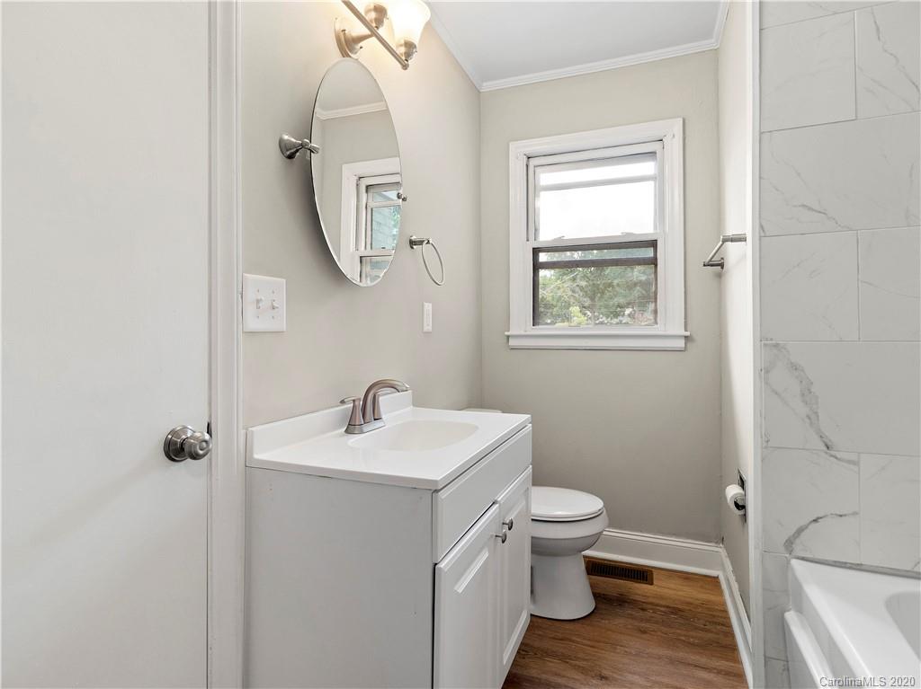 4152 Blenhein Road Charlotte, NC 28208 - Photo 25 of 34 a bathroom with a toilet a sink and a mirror