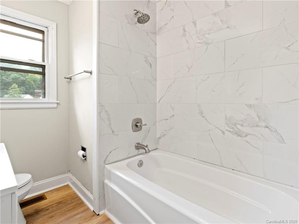 4152 Blenhein Road Charlotte, NC 28208 - Photo 27 of 34 a bathroom with a tub shower and vanity