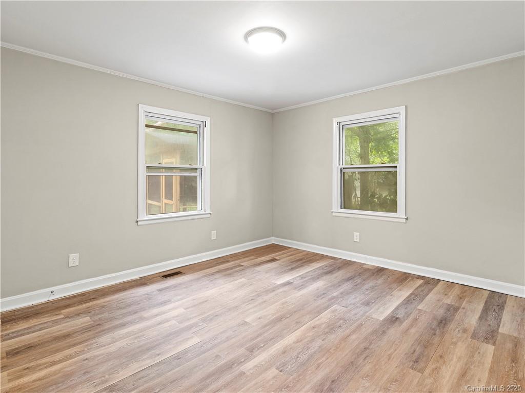 4152 Blenhein Road Charlotte, NC 28208 - Photo 28 of 34 a view of empty room with wooden floor and fan