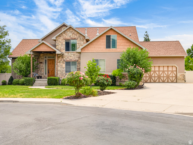 1279 West 1500th Street North Mapleton, UT 84664 - Photo 83 of 83 Stone and stucco exterior featuring a prominent two-car garage with decorative doors