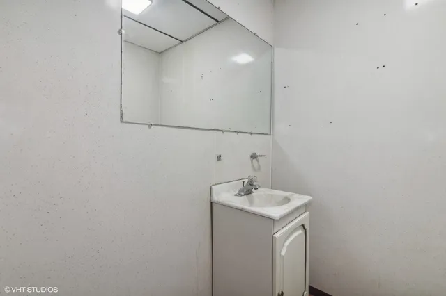 a bathroom with a sink and mirror