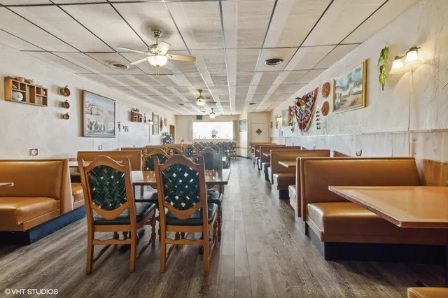 a dining room with furniture and wooden floor