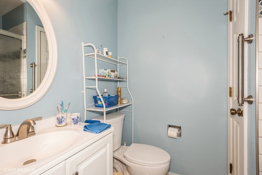 -n116 Windermere Road, Unit 2001 Winfield, IL 60190 - Photo 8 of 12 a bathroom with a sink a toilet and a mirror