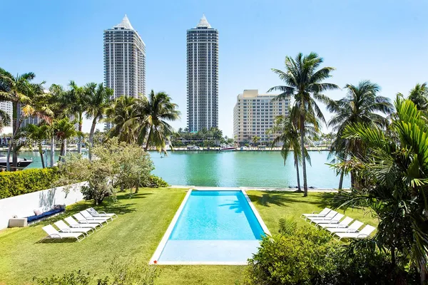 a view of a city with tall buildings and a big yard