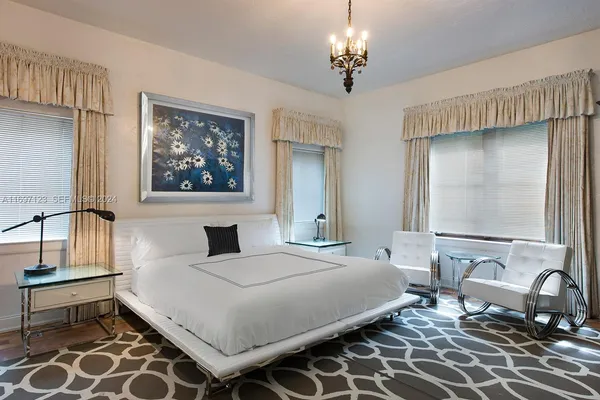 a bedroom with a bed and a chandelier