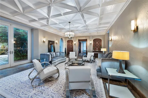 a living room with furniture and a chandelier
