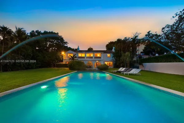 a view of an house with swimming pool having outdoor seating
