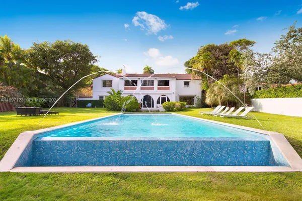 a view of swimming pool with outdoor seating and yard
