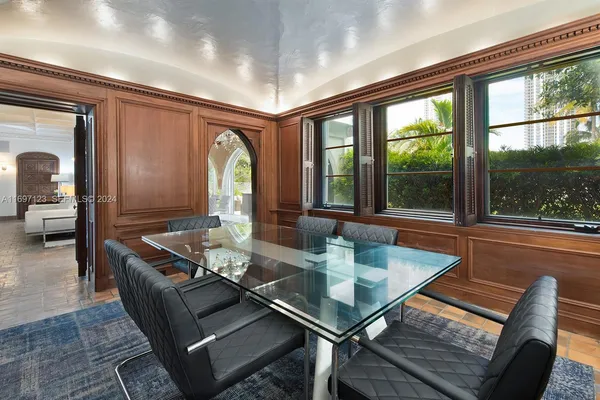 a dining room with furniture a chandelier and wooden floor