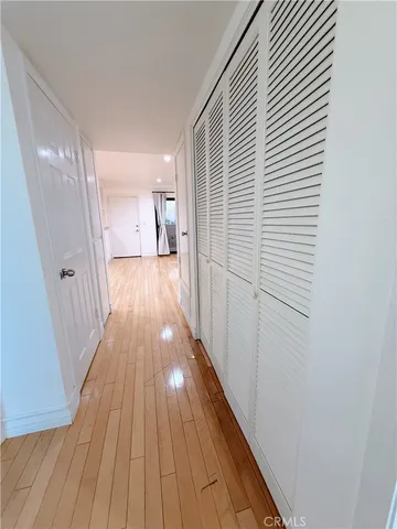 a view of a hallway with wooden floor