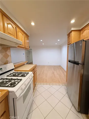 a kitchen with a stove a refrigerator and a cabinets