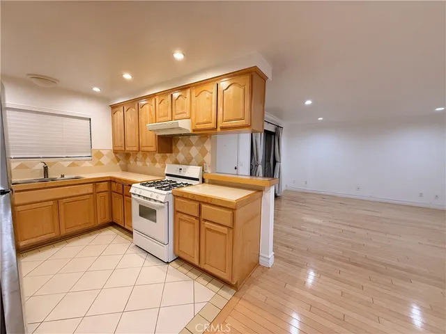a kitchen with a stove top oven sink and cabinets