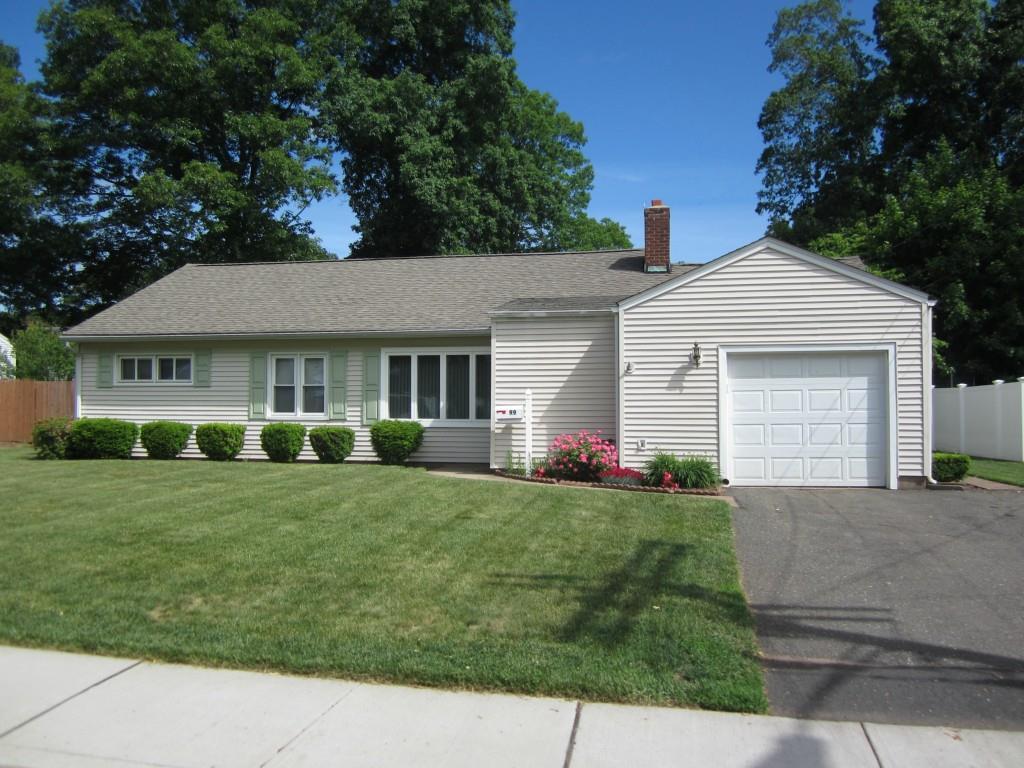 99 Green Manor Road Manchester, CT 06042 - Photo 1 of 1 a front view of a house with a yard and garage