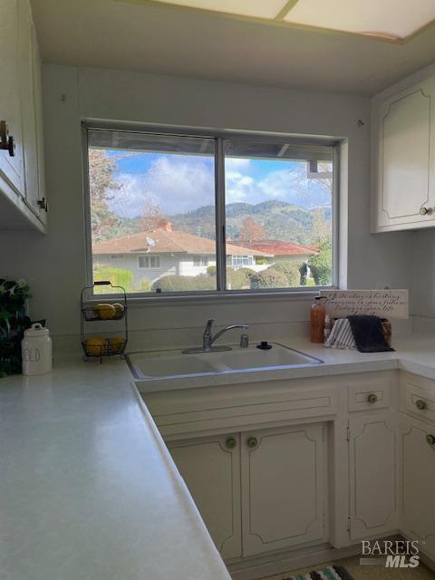27 Woodgreen Street Santa Rosa, CA 95409 - Photo 7 of 11 a kitchen with kitchen island a sink a stove and a window