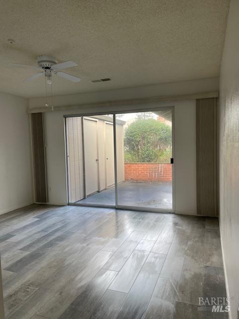 27 Woodgreen Street Santa Rosa, CA 95409 - Photo 9 of 11 an empty room with wooden floor and windows
