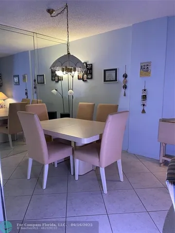 a dining room with furniture and chandelier