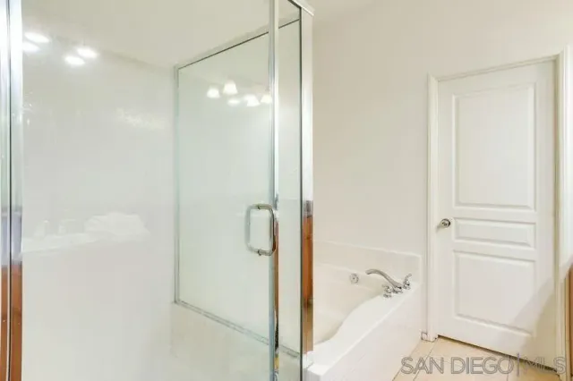 a bathroom with a glass shower door