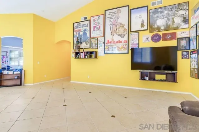 a view of a room with furniture and a flat screen tv