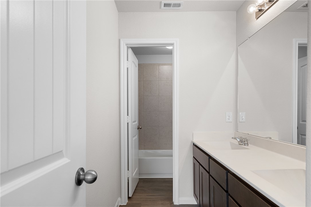 4702 Nopalitos Way Bryan, TX 77807 - Photo 25 of 27 a bathroom with a sink and a mirror