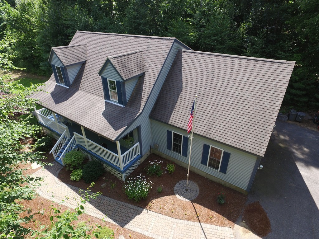 a aerial view of a house with a yard and balcony