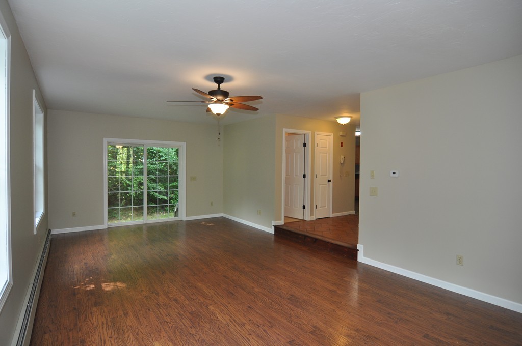 496 Loring Road Barre, MA 01005 - Photo 11 of 27 a view of an empty room with a window and wooden floor