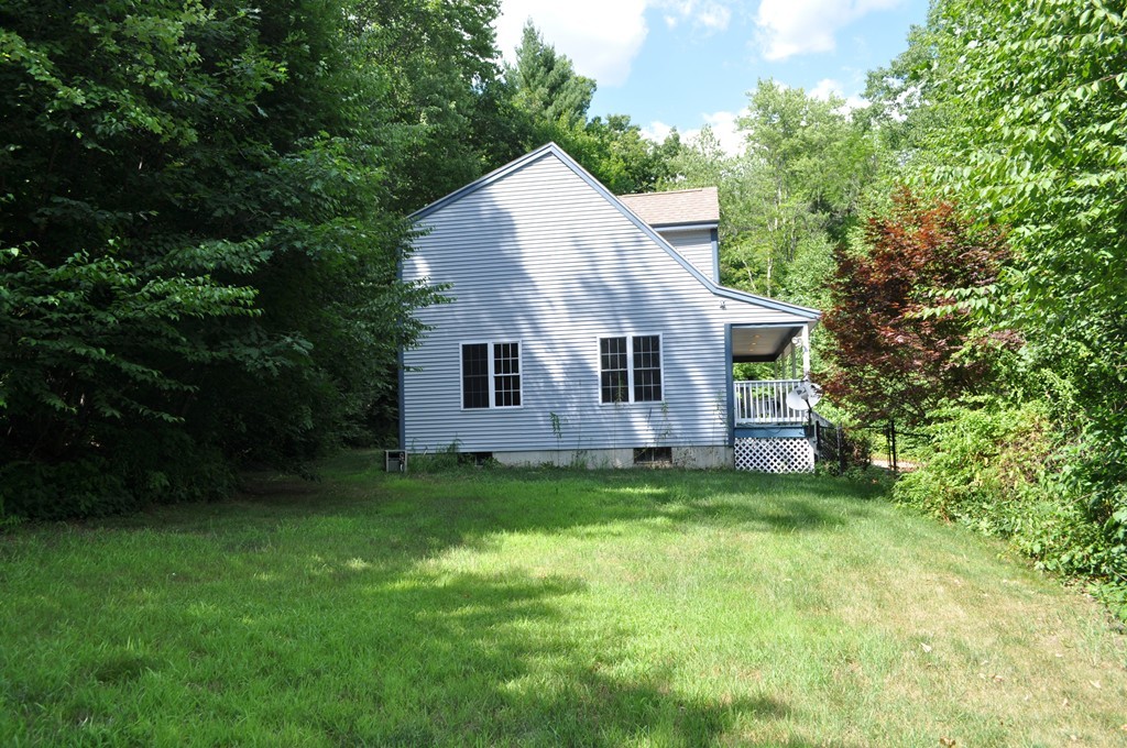 496 Loring Road Barre, MA 01005 - Photo 23 of 27 a aerial view of a house next to a big yard and large trees