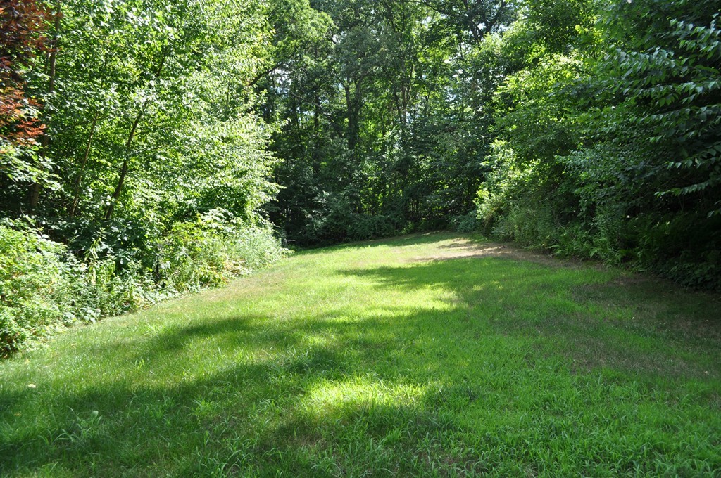 496 Loring Road Barre, MA 01005 - Photo 24 of 27 a backyard of a house with lots of plants and trees