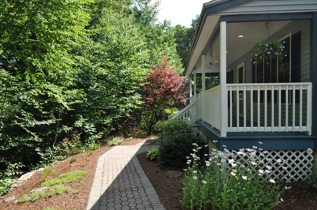 496 Loring Road Barre, MA 01005 - Photo 3 of 27 a side view of a house with a flower garden