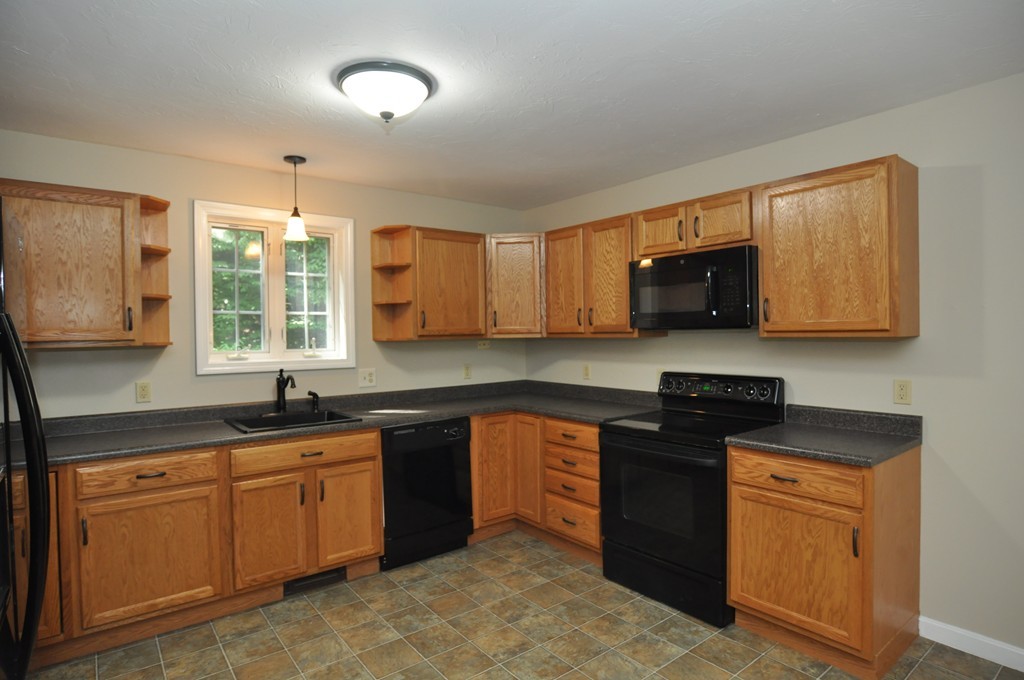 496 Loring Road Barre, MA 01005 - Photo 8 of 27 a kitchen with stainless steel appliances granite countertop a sink stove and microwave
