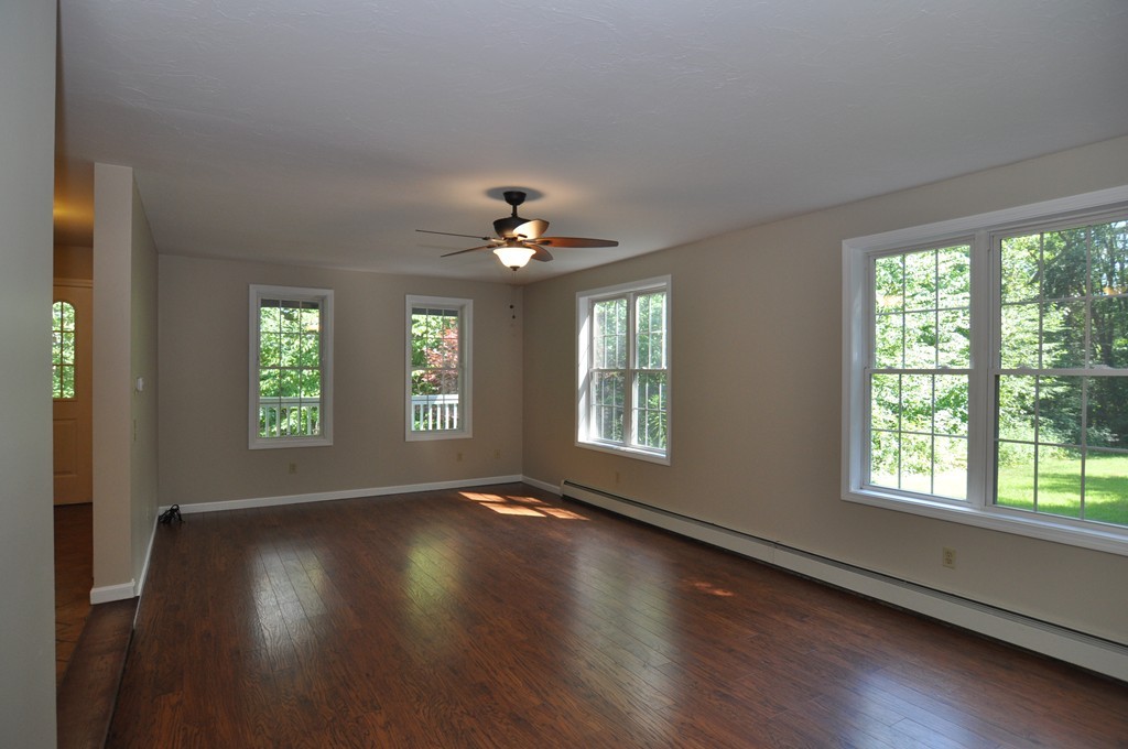 496 Loring Road Barre, MA 01005 - Photo 10 of 27 a view of an empty room with wooden floor and a window