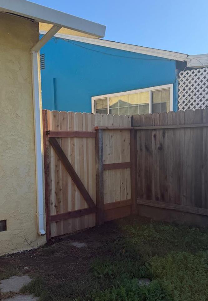 725 Sycamore Avenue Gustine, CA 95322 - Photo 18 of 31 a view of backyard with small cabin and wooden fencing