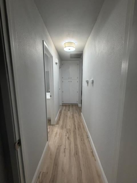 725 Sycamore Avenue Gustine, CA 95322 - Photo 28 of 31 a view of hallway with wooden floor