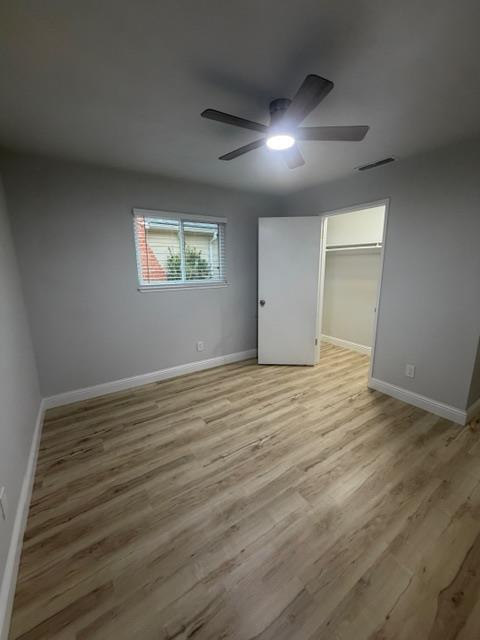 725 Sycamore Avenue Gustine, CA 95322 - Photo 30 of 31 an empty room with wooden floor and windows