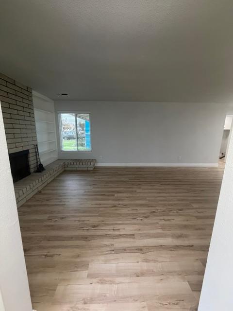 725 Sycamore Avenue Gustine, CA 95322 - Photo 5 of 31 a view of wooden floor and windows in a room