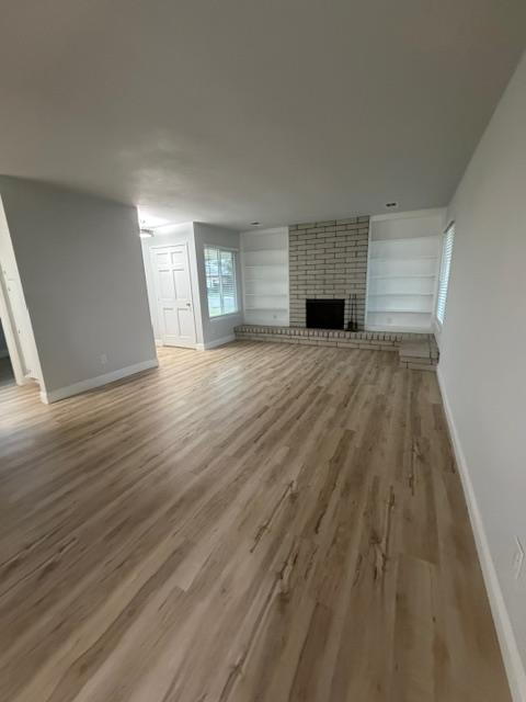 725 Sycamore Avenue Gustine, CA 95322 - Photo 7 of 31 an empty room with wooden floor and windows