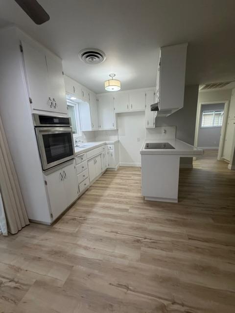 725 Sycamore Avenue Gustine, CA 95322 - Photo 10 of 31 a kitchen with stainless steel appliances a stove a microwave a sink and cabinets