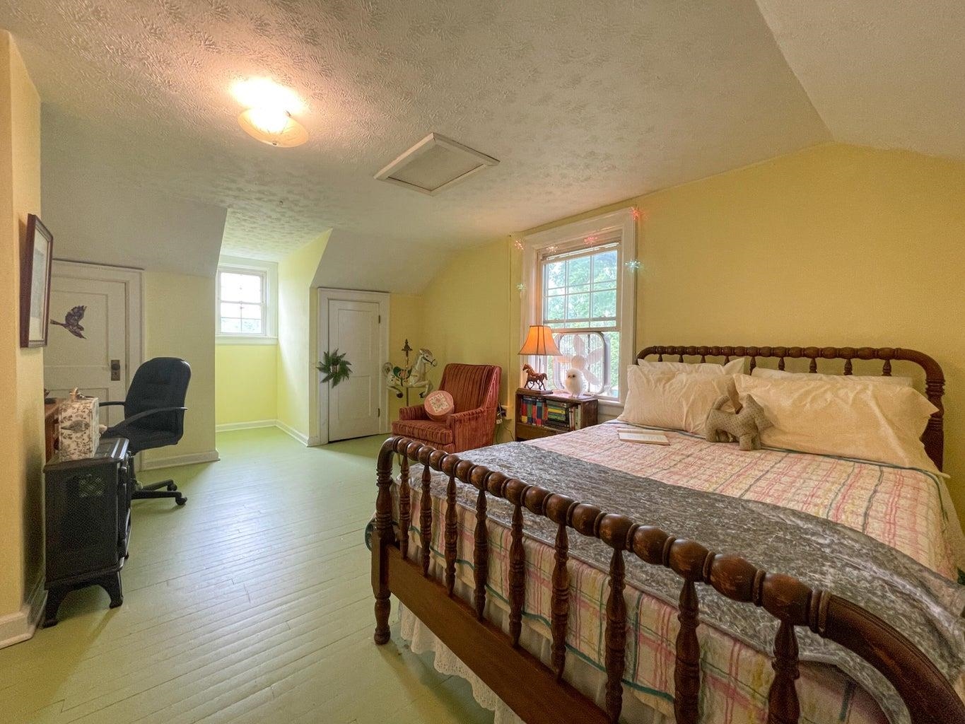 3416 Forge Road Glasgow, VA 24555 - Photo 22 of 51 a bedroom with a bed and wooden floor