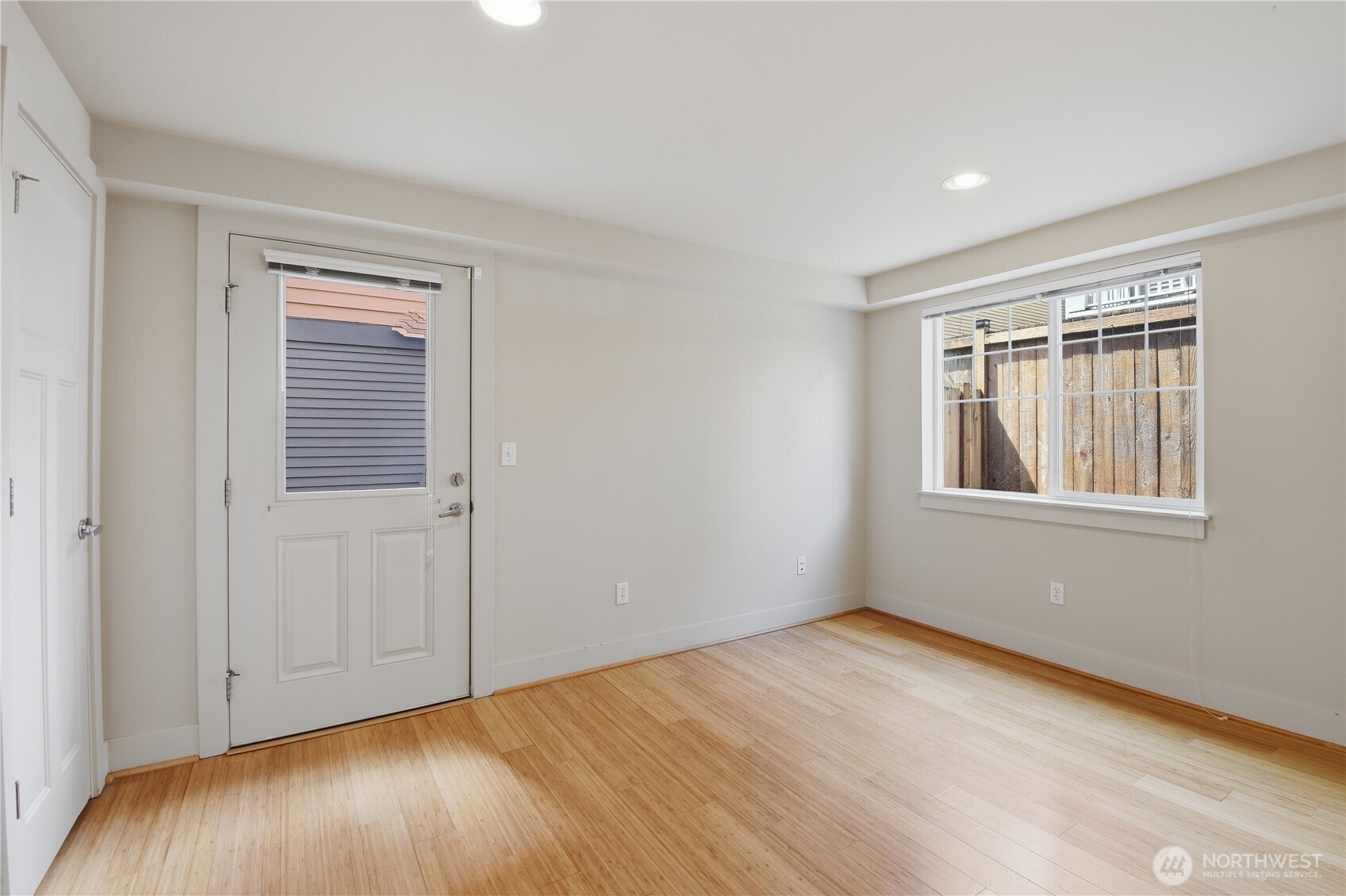 723 North 95th Street, Unit A Seattle, WA 98103 - Photo 10 of 20 a view of an empty room with wooden floor and a window