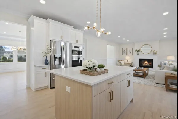 a kitchen with stainless steel appliances a stove refrigerator and a fireplace