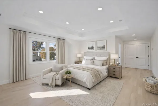 a bedroom with a large bed and a window