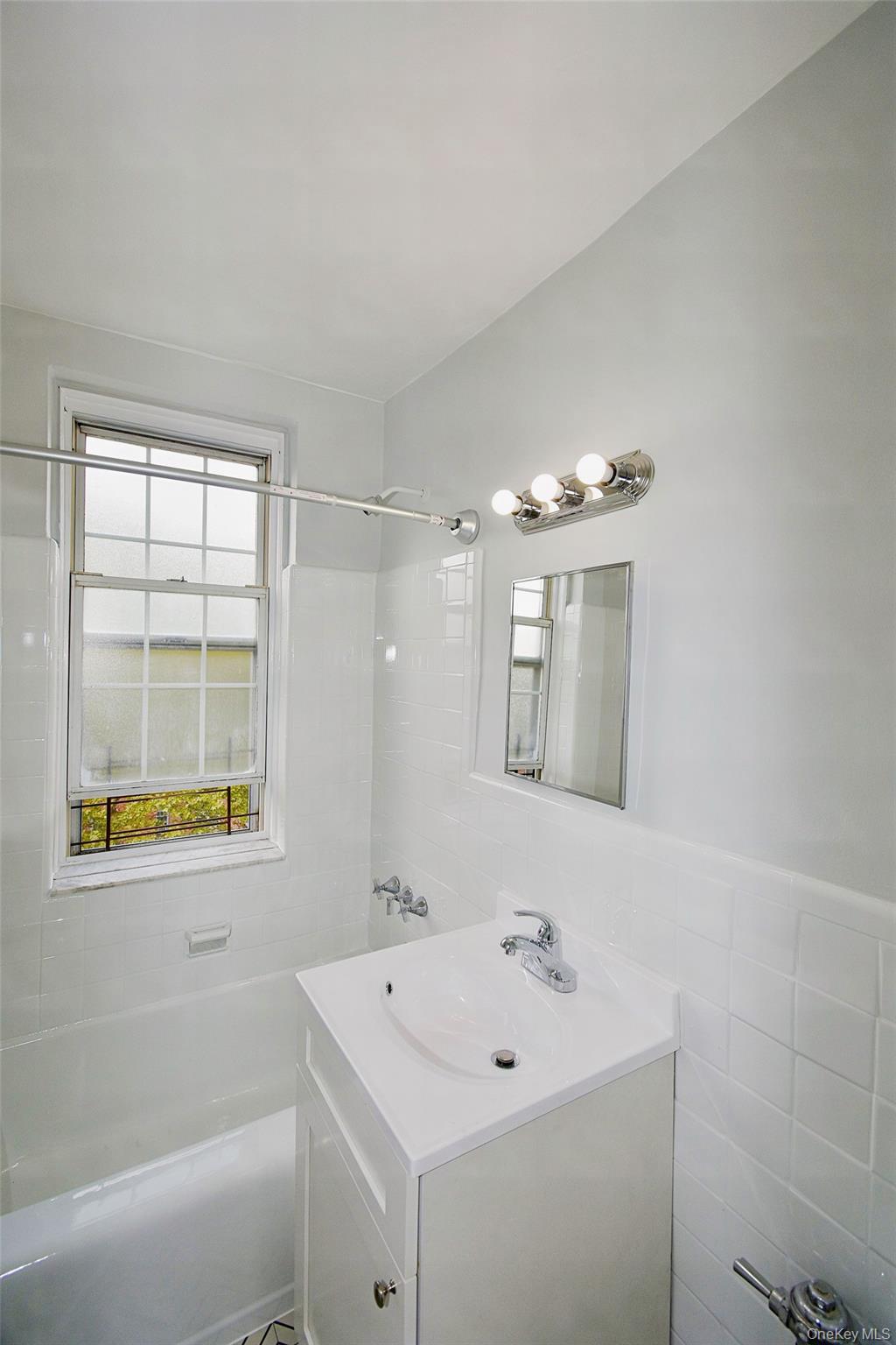 786 Bronx River Road, Unit B56 Bronxville, NY 10708 - Photo 8 of 8 a bathroom with a sink mirror and a bathtub