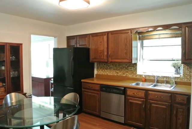 1334 Ridge Road Northbrook, IL 60062 - Photo 5 of 17 a kitchen with stainless steel appliances granite countertop a refrigerator and a sink